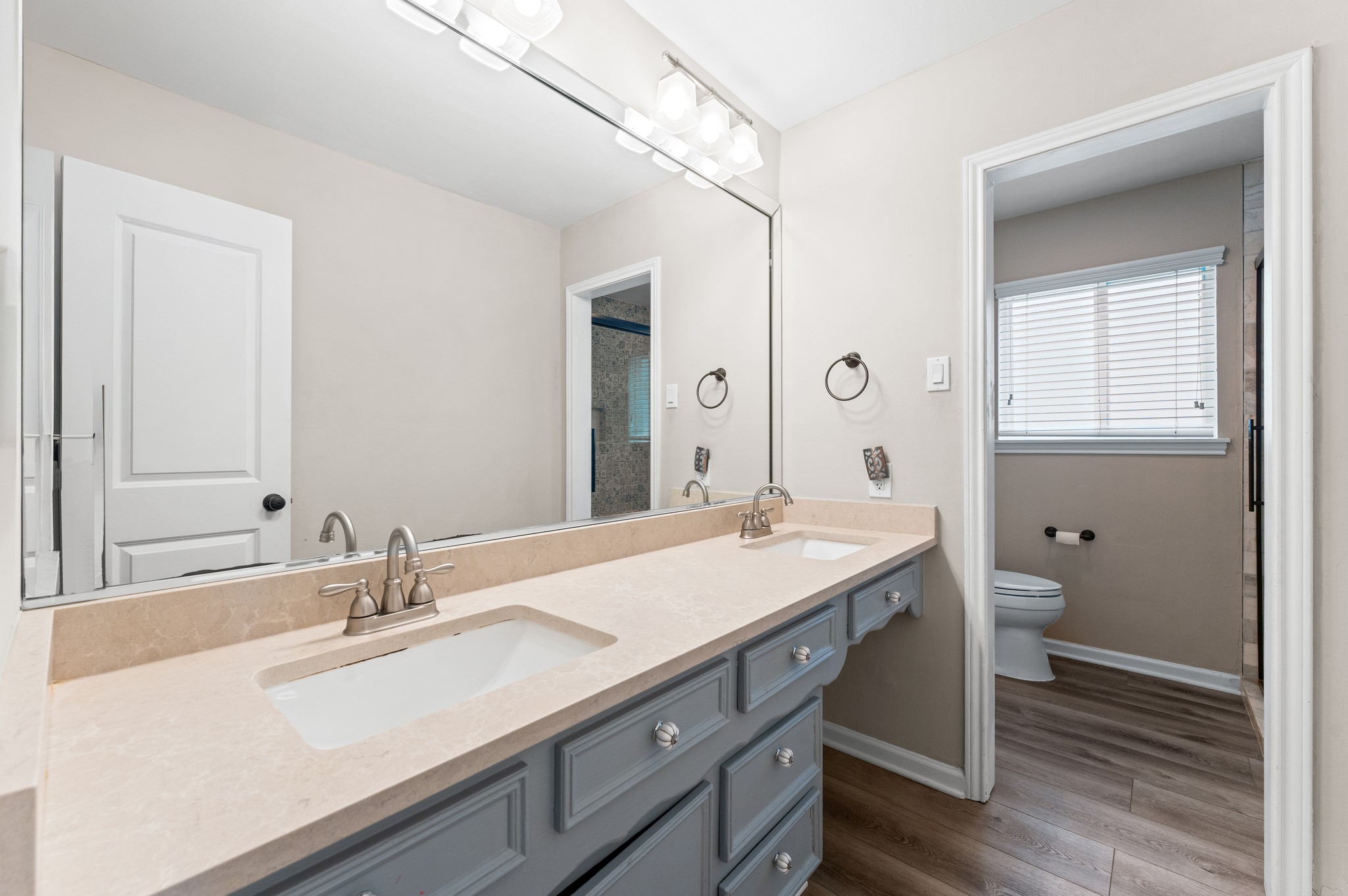 9407 Brooding Oak Circle Houston, TX 77096 - Photo 18 of 43 a bathroom with a granite countertop sink a toilet and a mirror