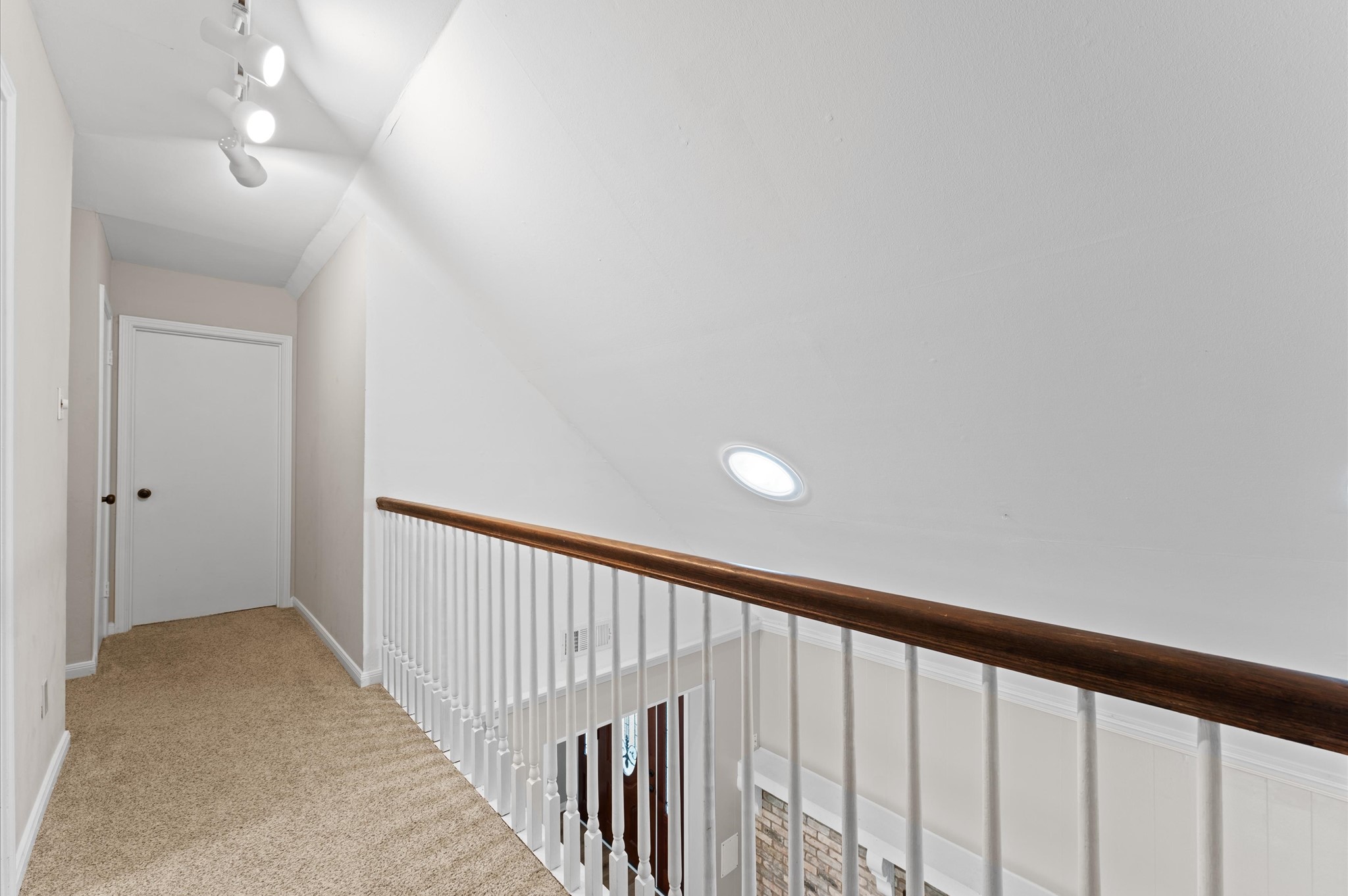 9407 Brooding Oak Circle Houston, TX 77096 - Photo 24 of 43 a view of a hallway with wooden floor and staircase