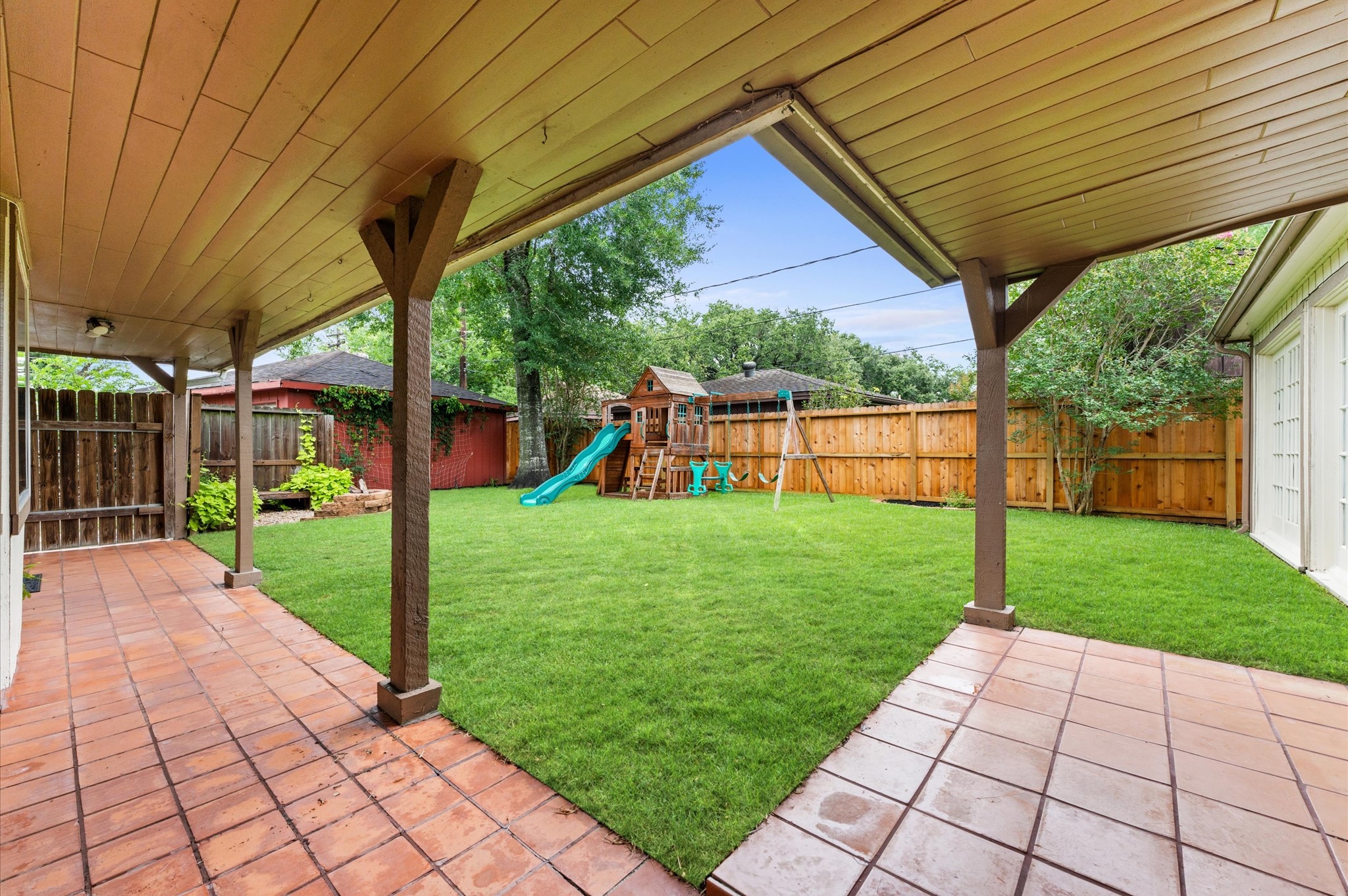 9407 Brooding Oak Circle Houston, TX 77096 - Photo 27 of 43 Spacious backyard with a covered patio, perfect for outdoor relaxation.