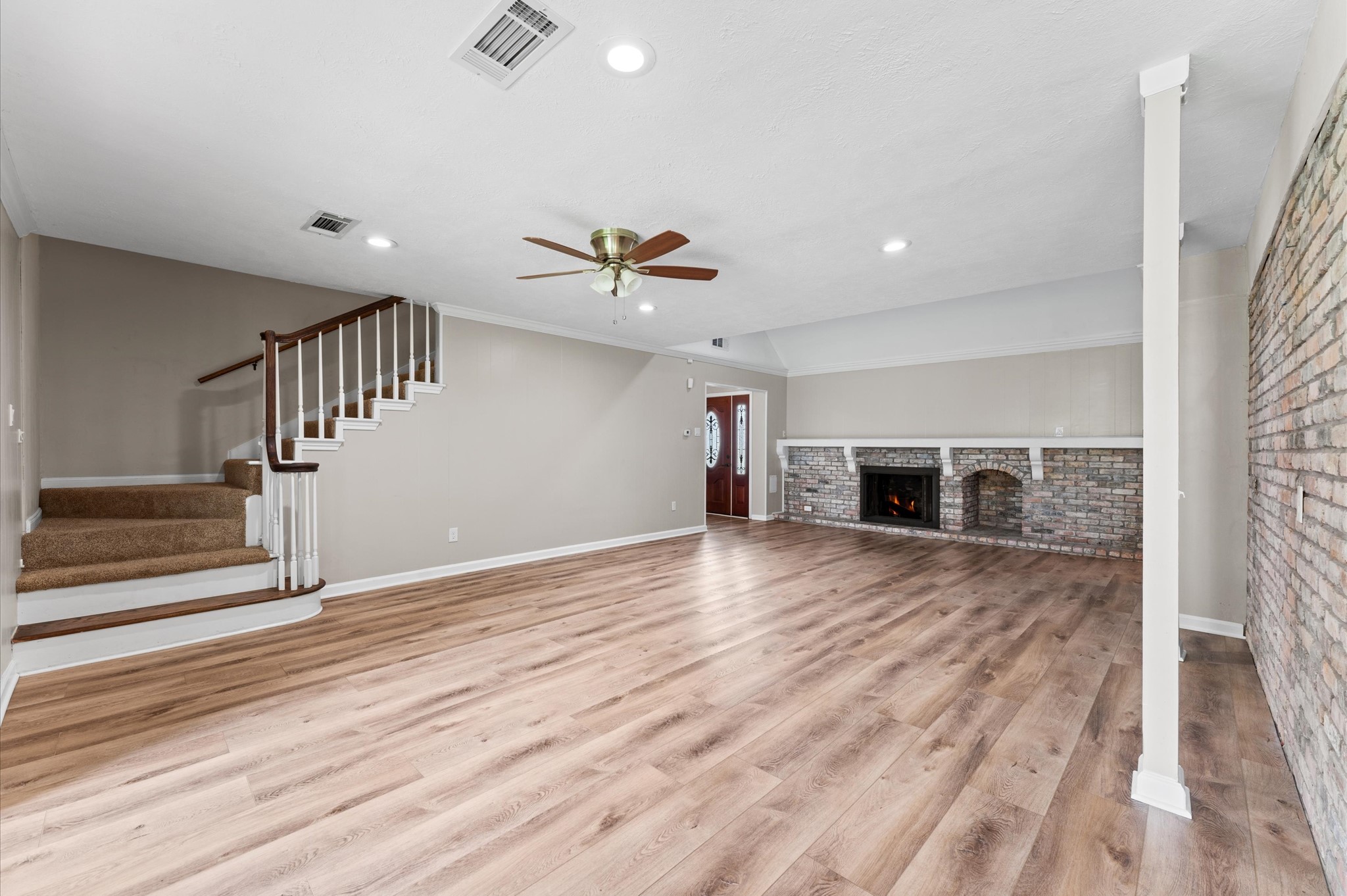 9407 Brooding Oak Circle Houston, TX 77096 - Photo 9 of 43 a view of a livingroom with wooden floor and a ceiling fan
