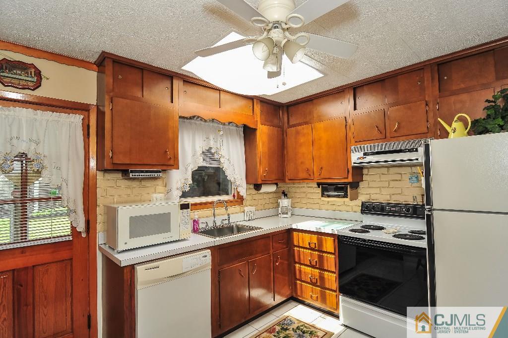 20 Roger Road Edison, NJ 08817 - Photo 12 of 25 a kitchen with stainless steel appliances a stove sink and cabinets