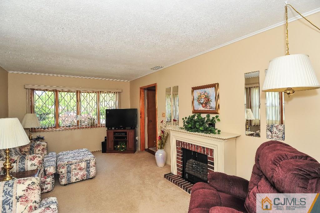 20 Roger Road Edison, NJ 08817 - Photo 6 of 25 a living room with furniture fireplace and window
