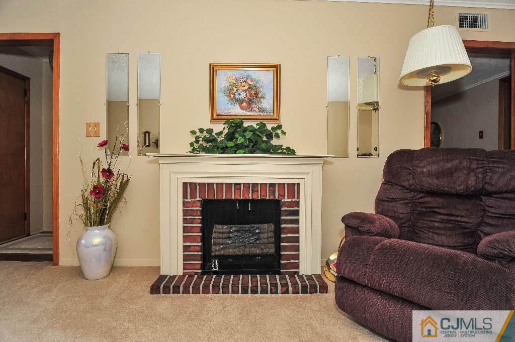 20 Roger Road Edison, NJ 08817 - Photo 7 of 25 a living room with furniture a fireplace and a window