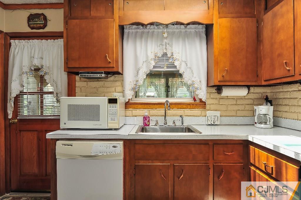 20 Roger Road Edison, NJ 08817 - Photo 10 of 25 a kitchen with stainless steel appliances a sink stove and cabinets