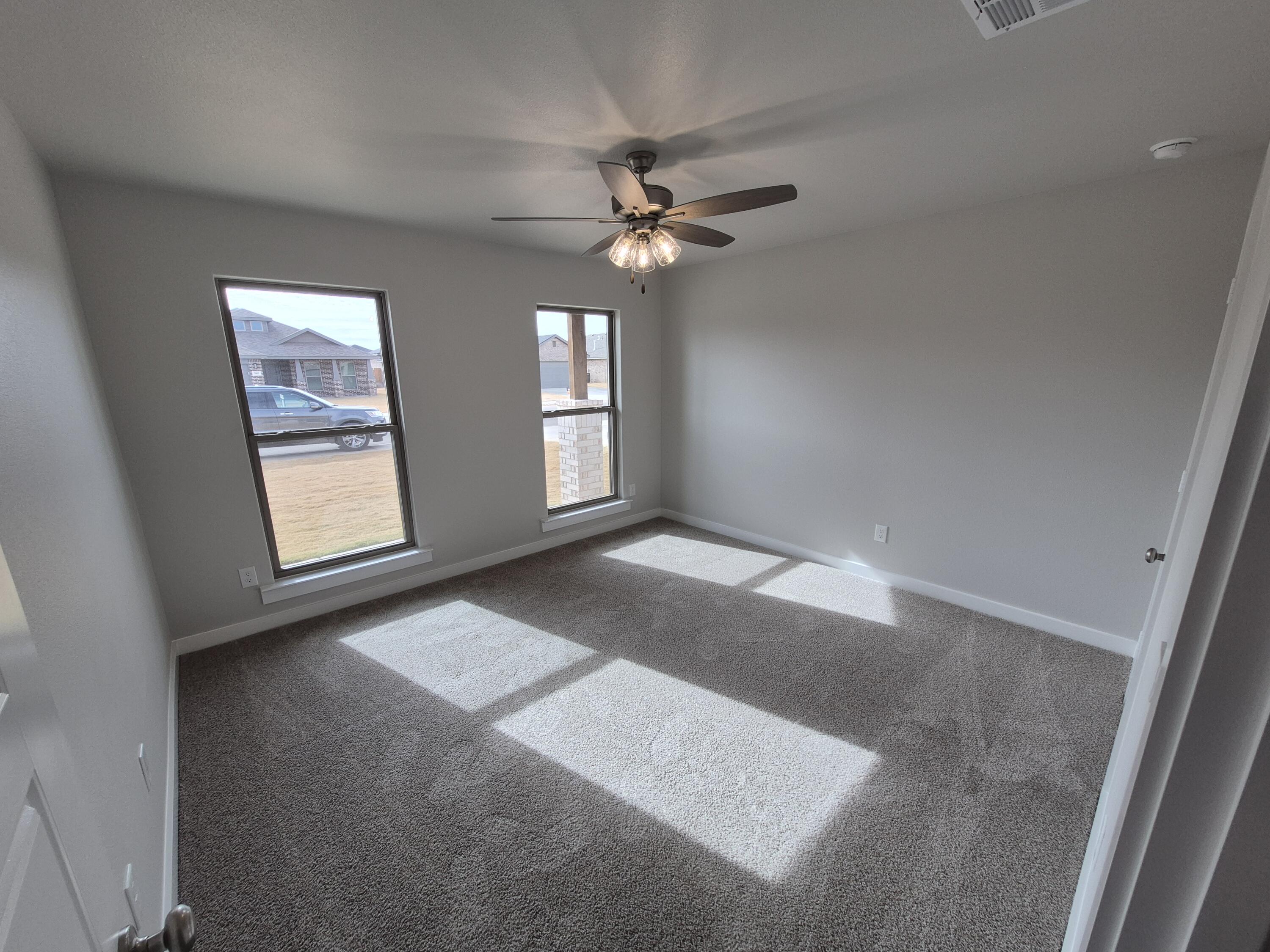 7008 14th Street Lubbock, TX 79416 - Photo 15 of 21 an empty room with windows and fan