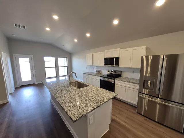 a kitchen with refrigerator and stove