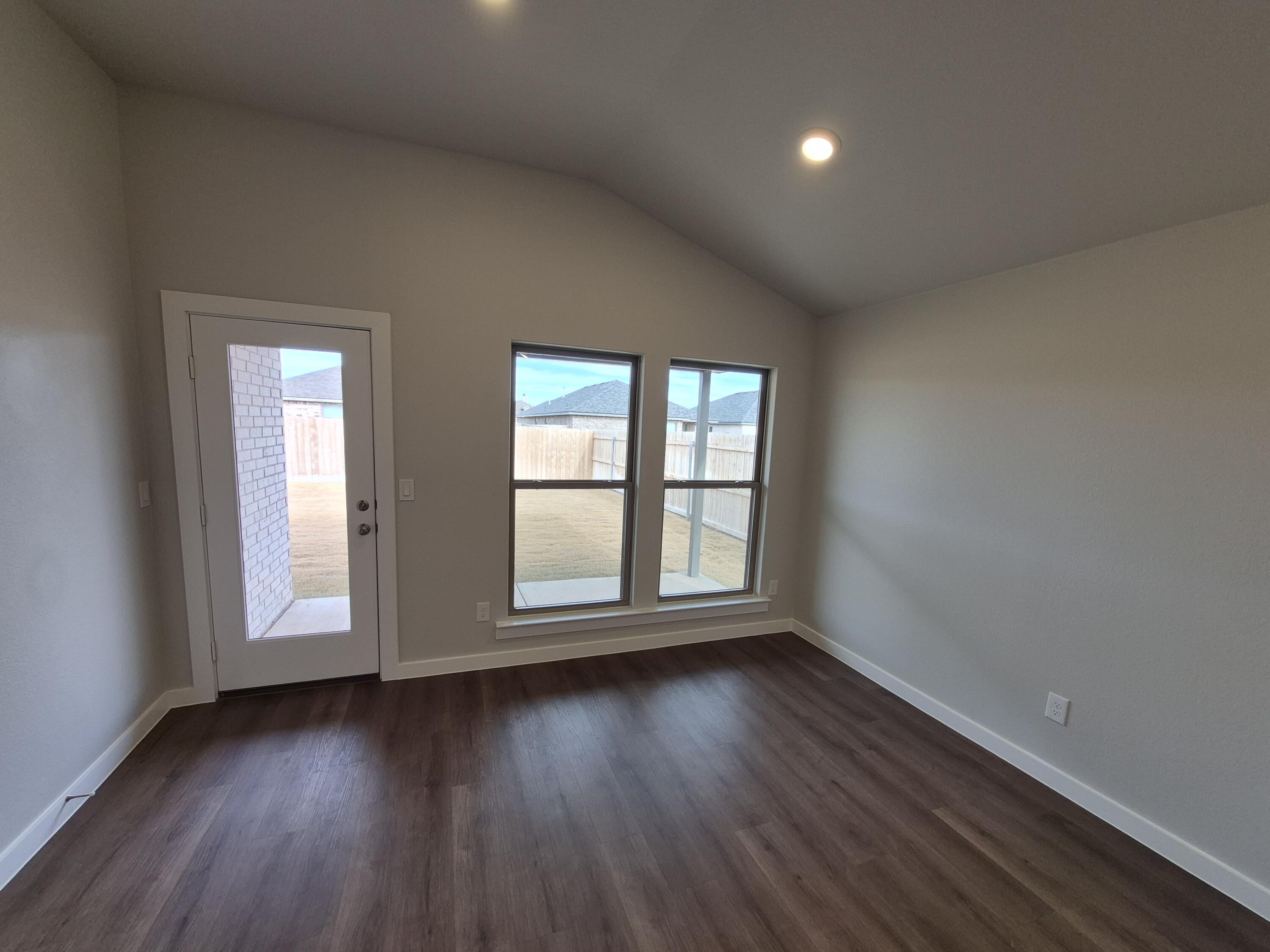 7008 14th Street Lubbock, TX 79416 - Photo 6 of 21 an empty room with wooden floor and windows
