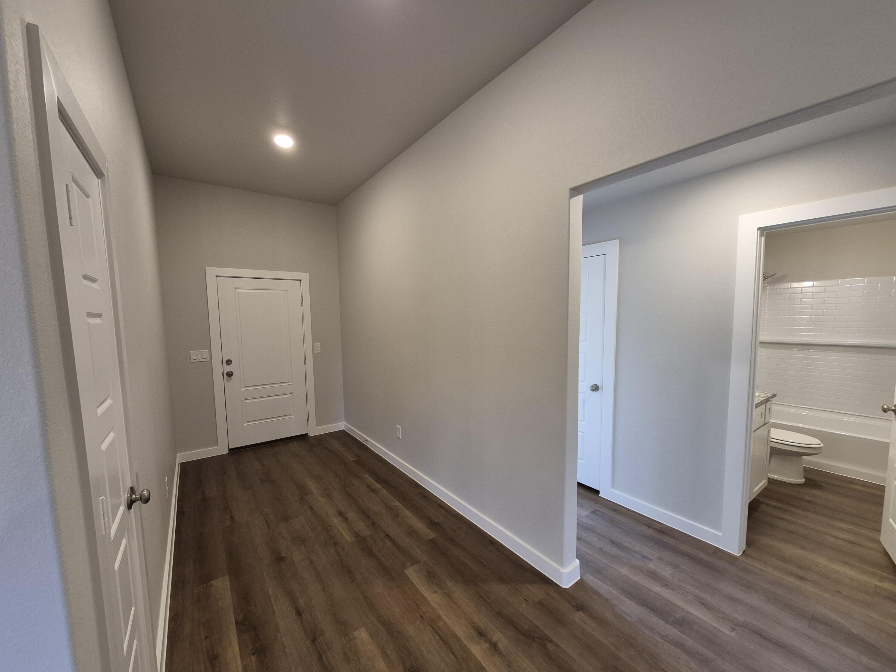 7008 14th Street Lubbock, TX 79416 - Photo 10 of 21 a view of a hallway with wooden floor and a bathroom