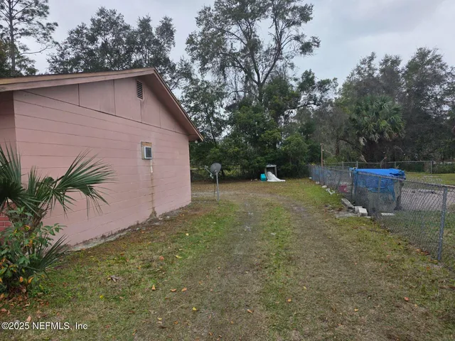 a backyard of a house with plants and trees