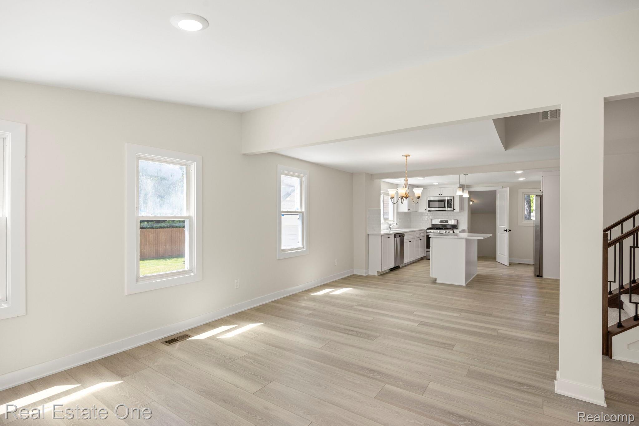 3200 Hessel Avenue Rochester, MI 48307 - Photo 6 of 32 Unfurnished living room with light wood finished floors and suspended lighting