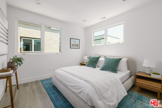 a bed room with a bed and a potted plant