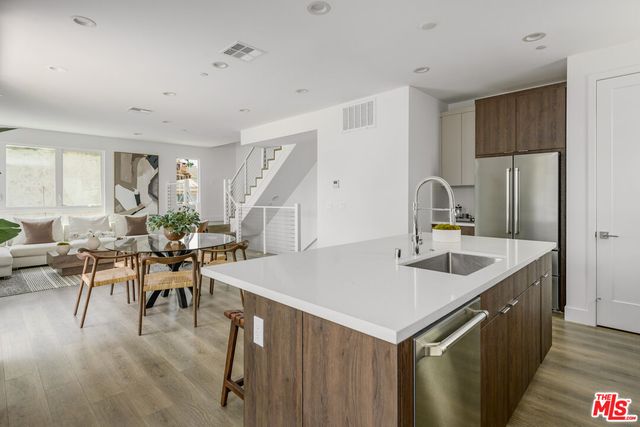 a kitchen with a table chairs and white cabinets