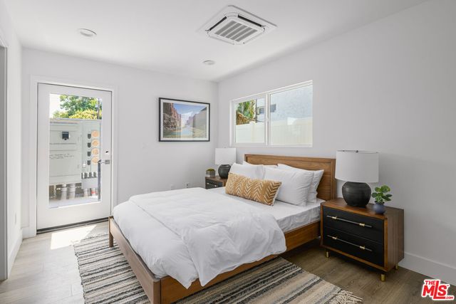 a bedroom with a bed and painting on the wall