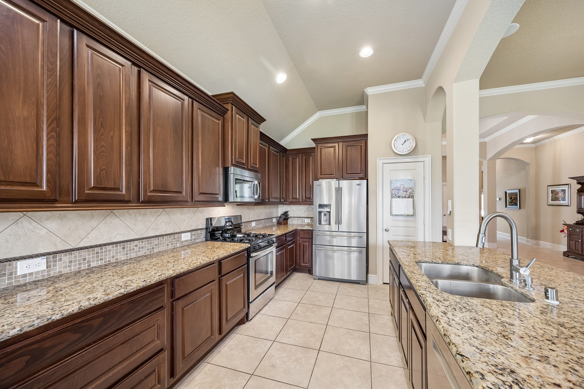14 Tallgrass Way Spring, TX 77389 - Photo 12 of 31 Kitchen featuring warm brown cabinets with lots of counter space