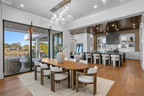 a kitchen with kitchen island granite countertop a sink cabinets and stainless steel appliances