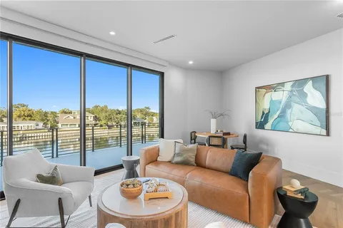 a bedroom with furniture and large windows