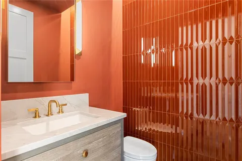 a large bathroom with a granite countertop sink a mirror a vanity and shower