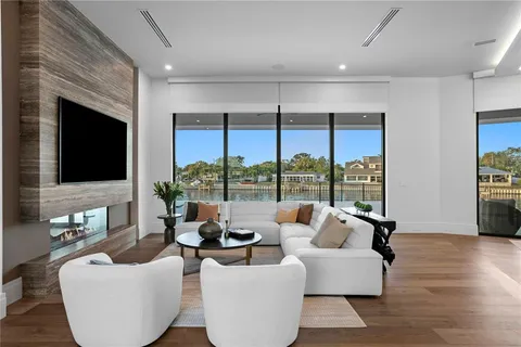 a living room with furniture fireplace and floor to ceiling window