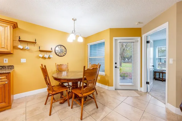 a view of a dining room with furniture and a window