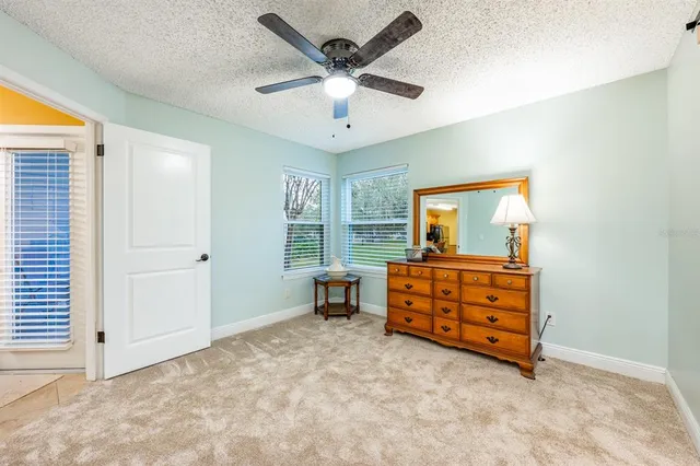 en empty room with window and ceiling fan