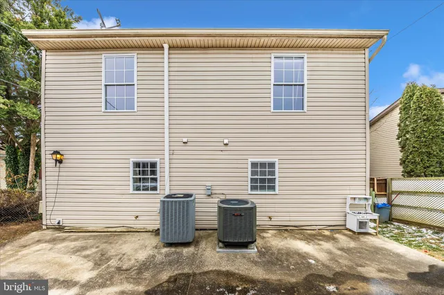 a view of a small house with backyard