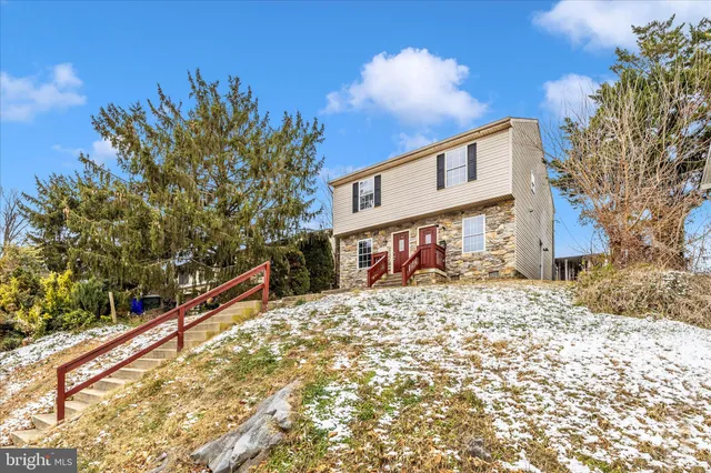 a view of a house with a snow on the road