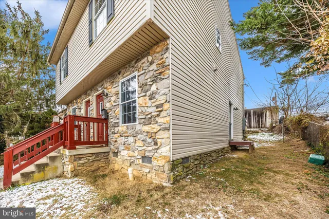 a view of a house with a wooden fence