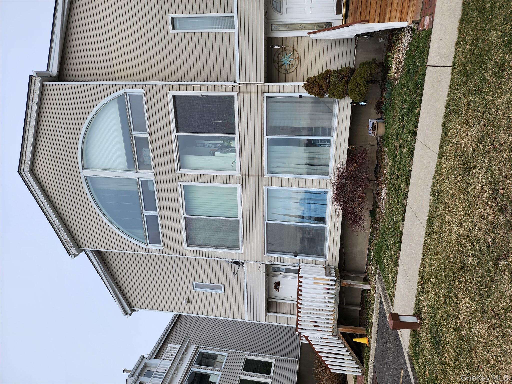 4 Landing Way, Unit 59 Bronx, NY 10464 - Photo 1 of 6 a front view of a house with a porch