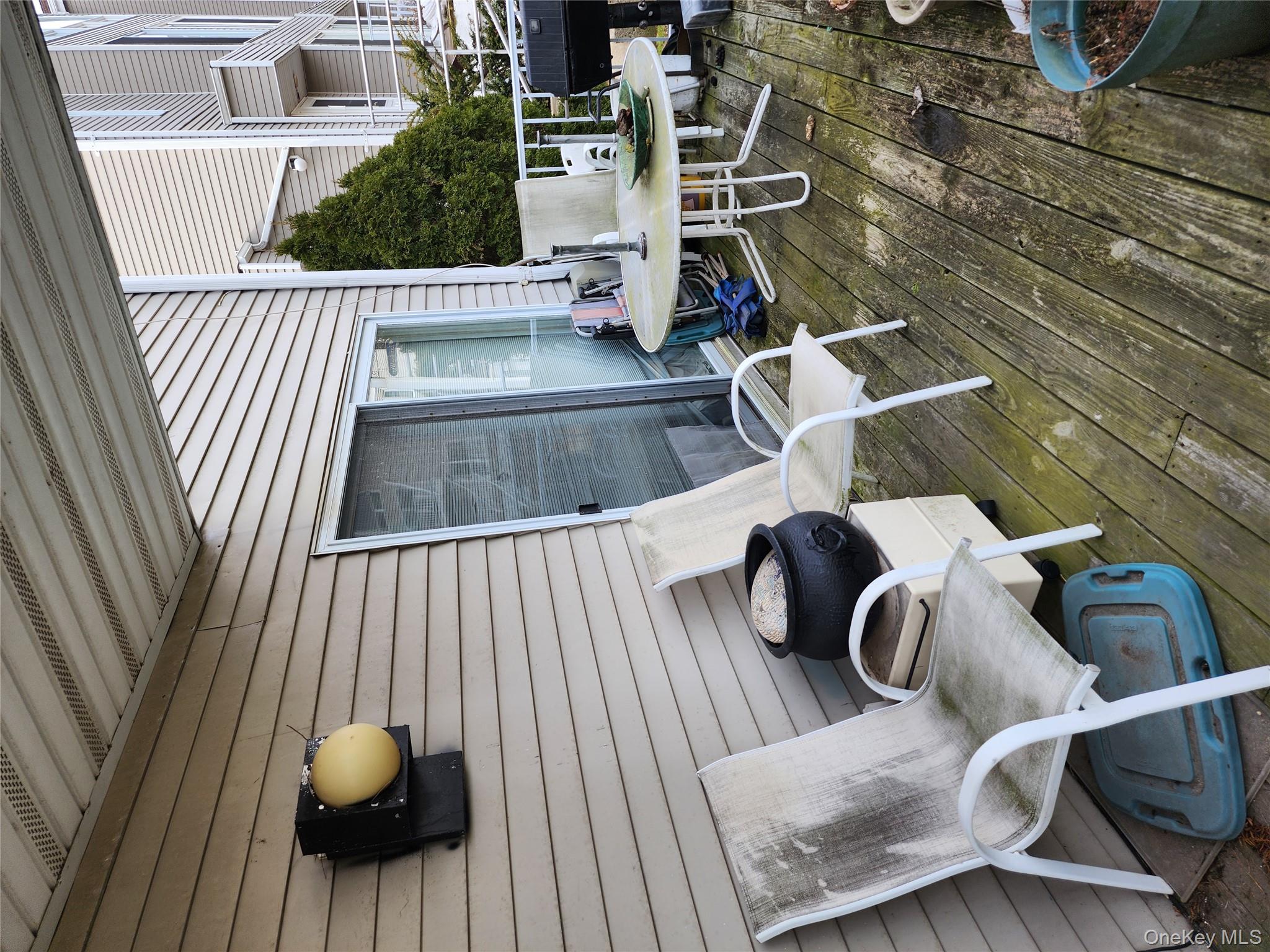 4 Landing Way, Unit 59 Bronx, NY 10464 - Photo 4 of 6 a balcony with table and chairs