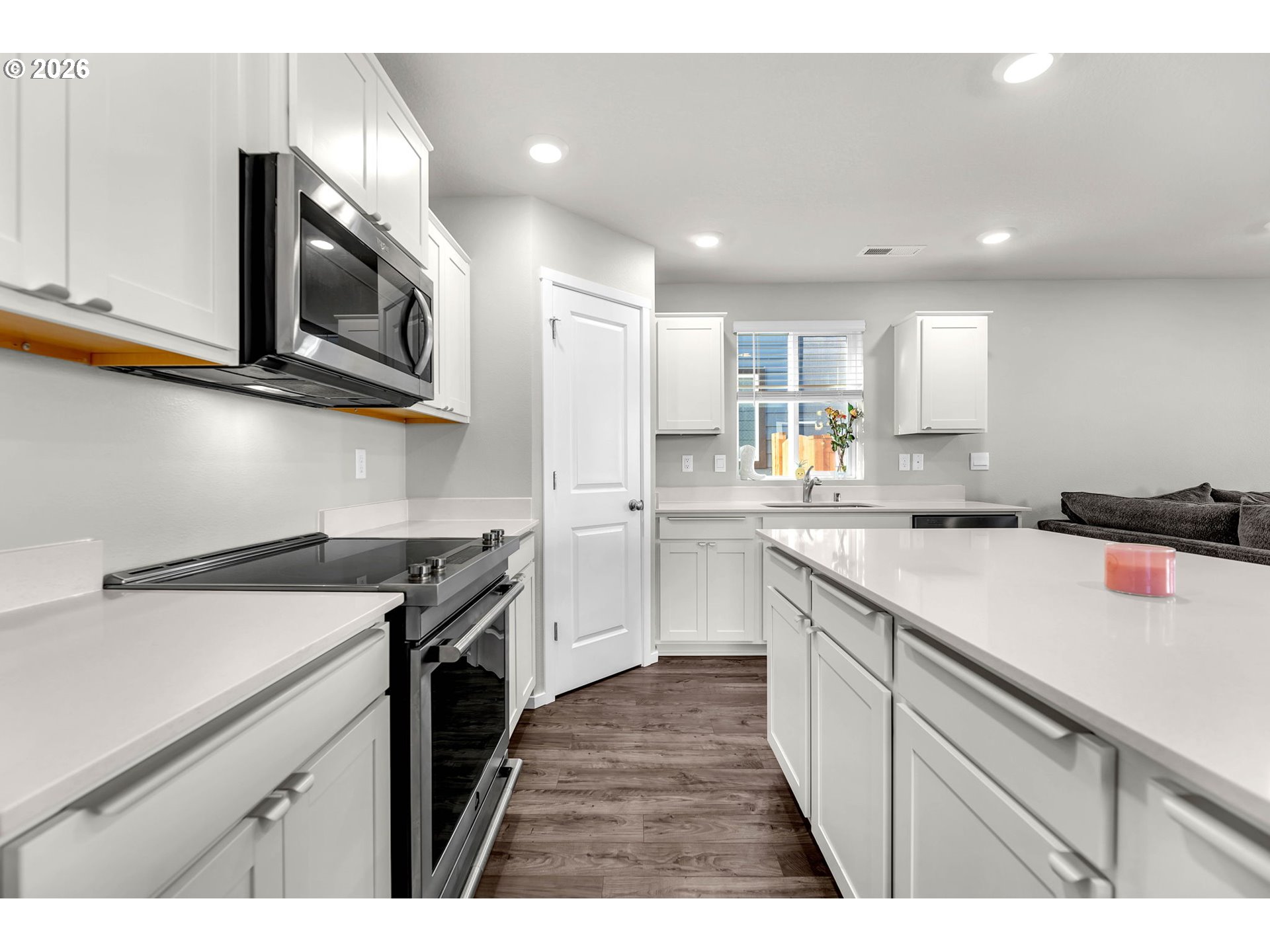 2936 North 3rd Way Ridgefield, WA 98642 - Photo 11 of 44 a kitchen with stainless steel appliances granite countertop a sink stove a microwave and cabinets