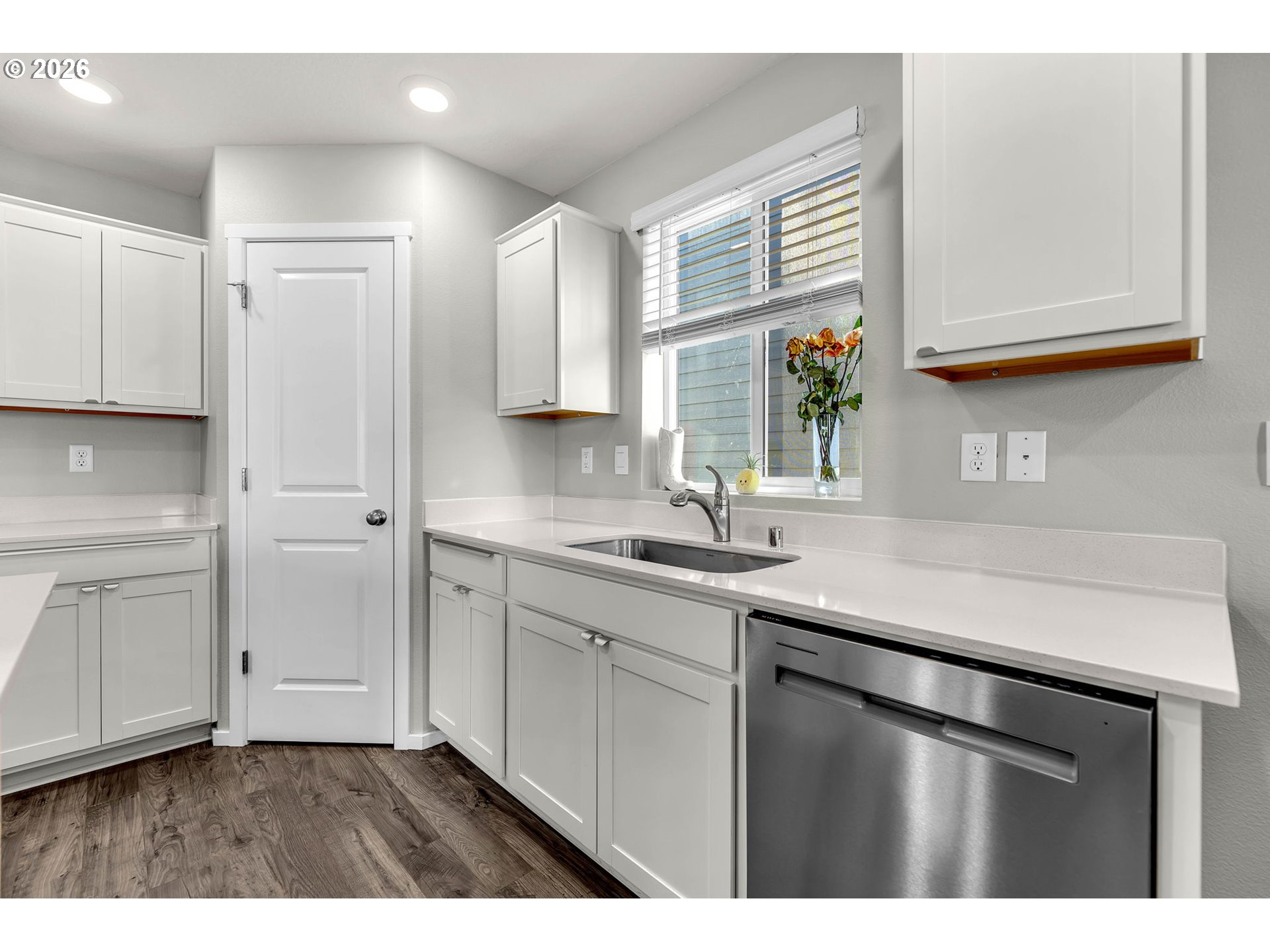 2936 North 3rd Way Ridgefield, WA 98642 - Photo 12 of 44 a kitchen with white cabinets and sink