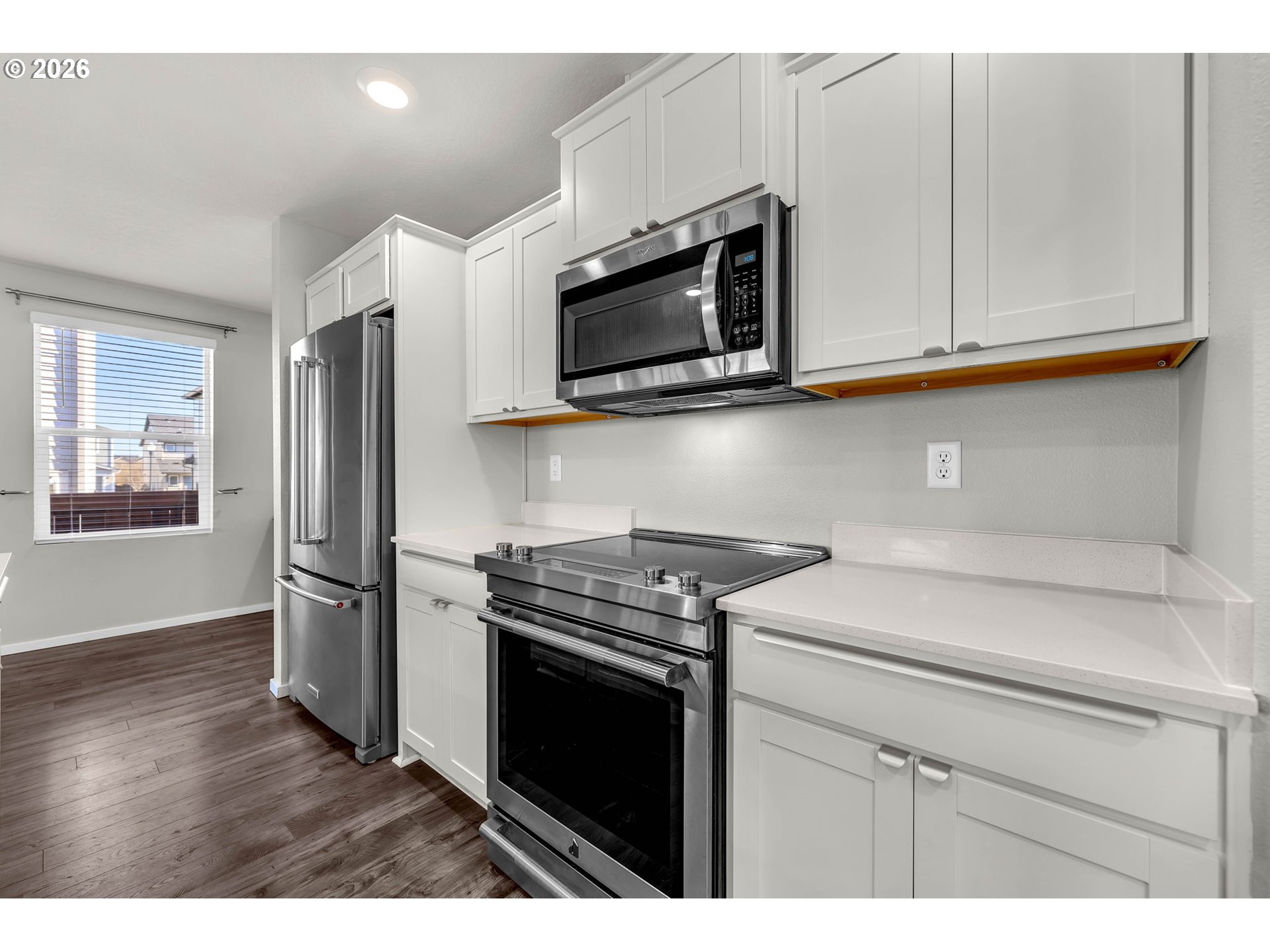 2936 North 3rd Way Ridgefield, WA 98642 - Photo 13 of 44 a kitchen with stainless steel appliances white cabinets and a stove top oven