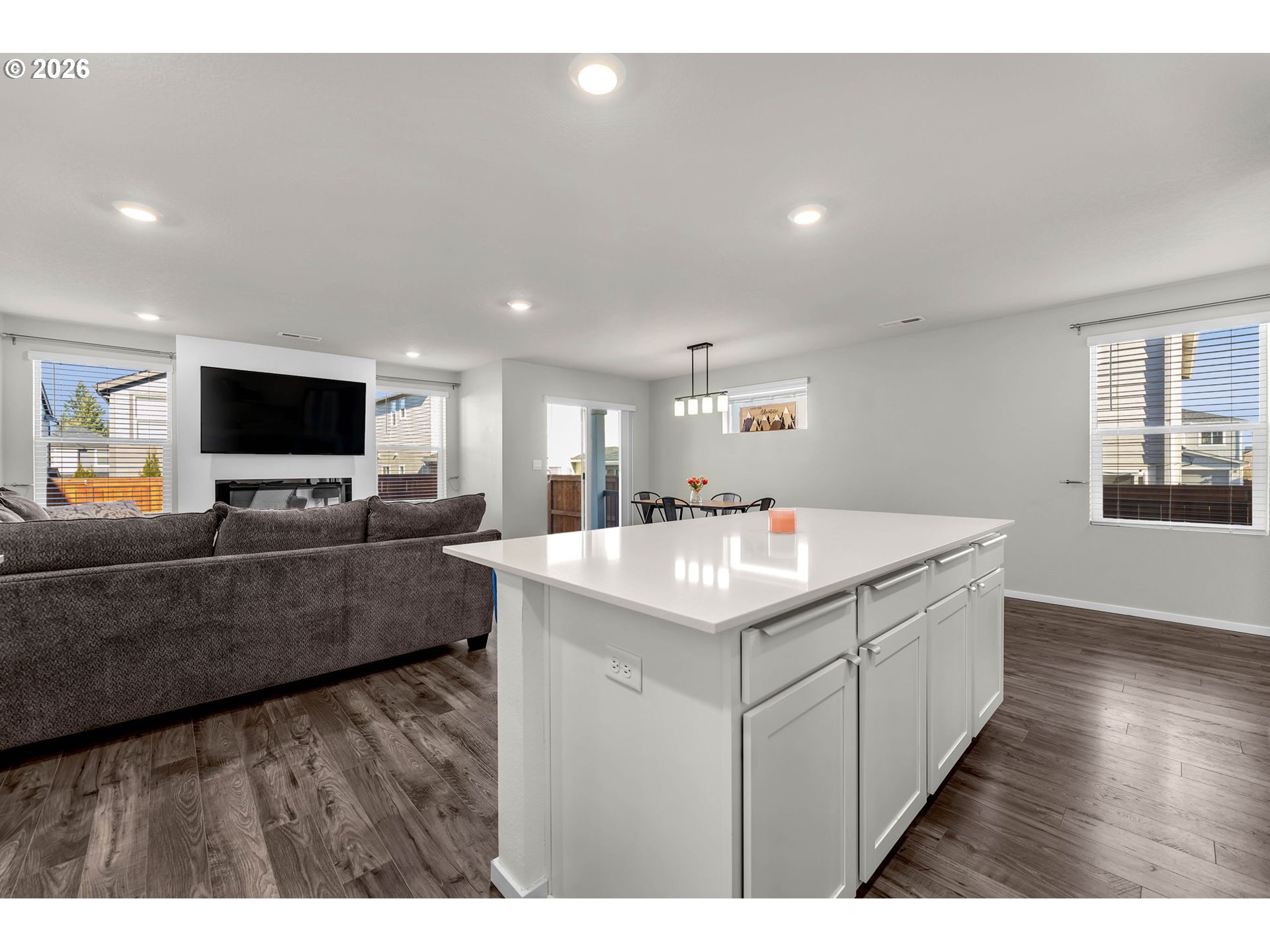 2936 North 3rd Way Ridgefield, WA 98642 - Photo 16 of 44 a living room with stainless steel appliances kitchen island a flat screen tv and a couch