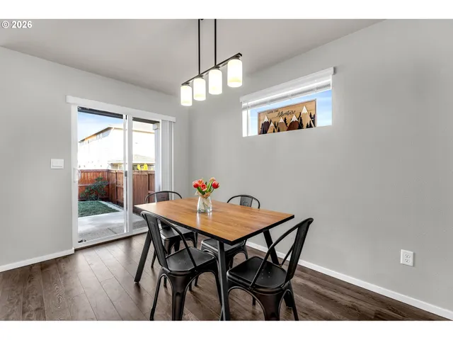 a view of a dining room with furniture wooden floor and chandelier