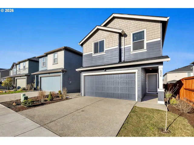 a front view of a house with a yard and garage