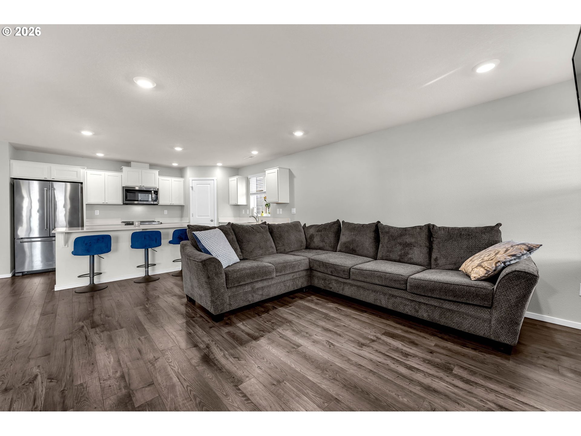 2936 North 3rd Way Ridgefield, WA 98642 - Photo 22 of 44 a living room with furniture and a dining table with kitchen view