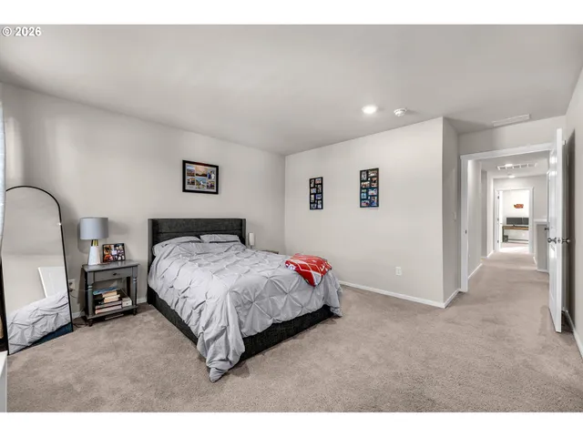 a spacious bedroom with a bed and a view