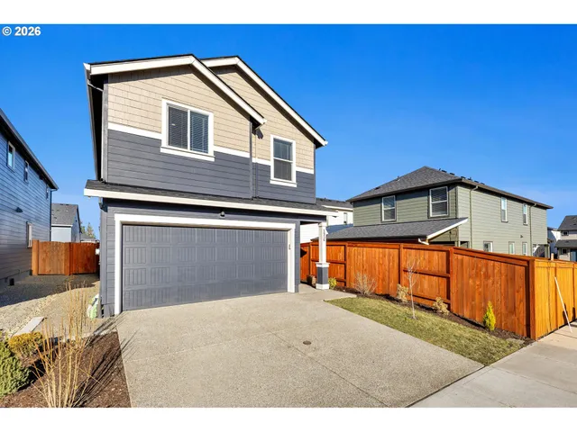 a view of a house with wooden fence