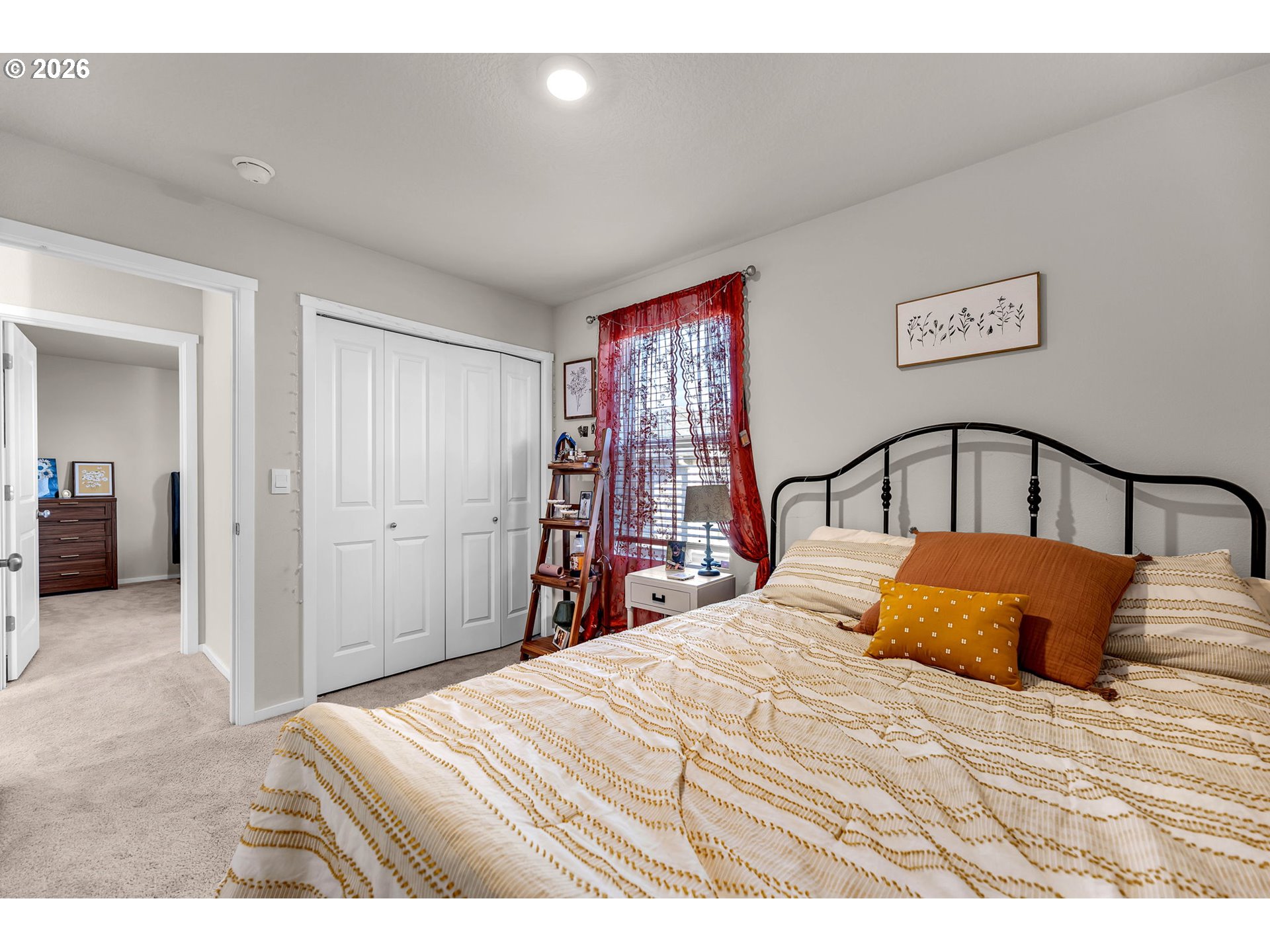 2936 North 3rd Way Ridgefield, WA 98642 - Photo 32 of 44 a bedroom with a large bed and a chandelier