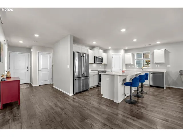 a view of kitchen with refrigerator microwave and wooden floor