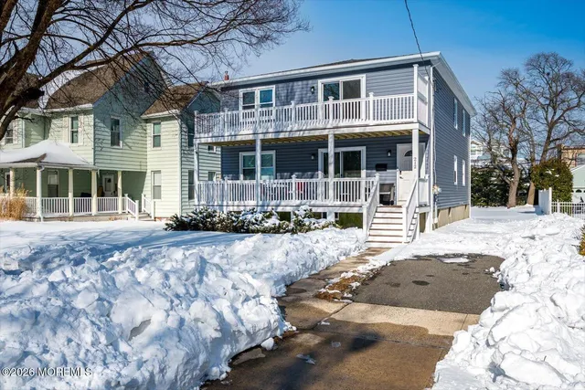 a view of a house with a yard covered in snow