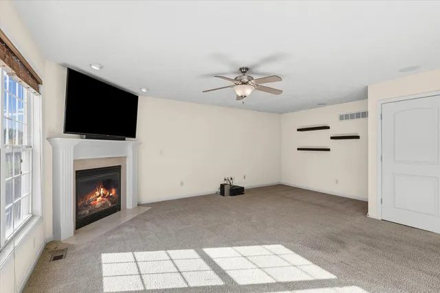 a living room with fireplace furniture and a flat screen tv
