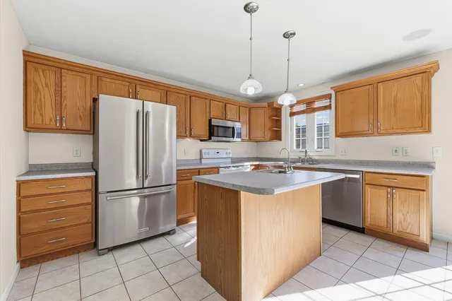 a kitchen with a sink a stove and cabinets