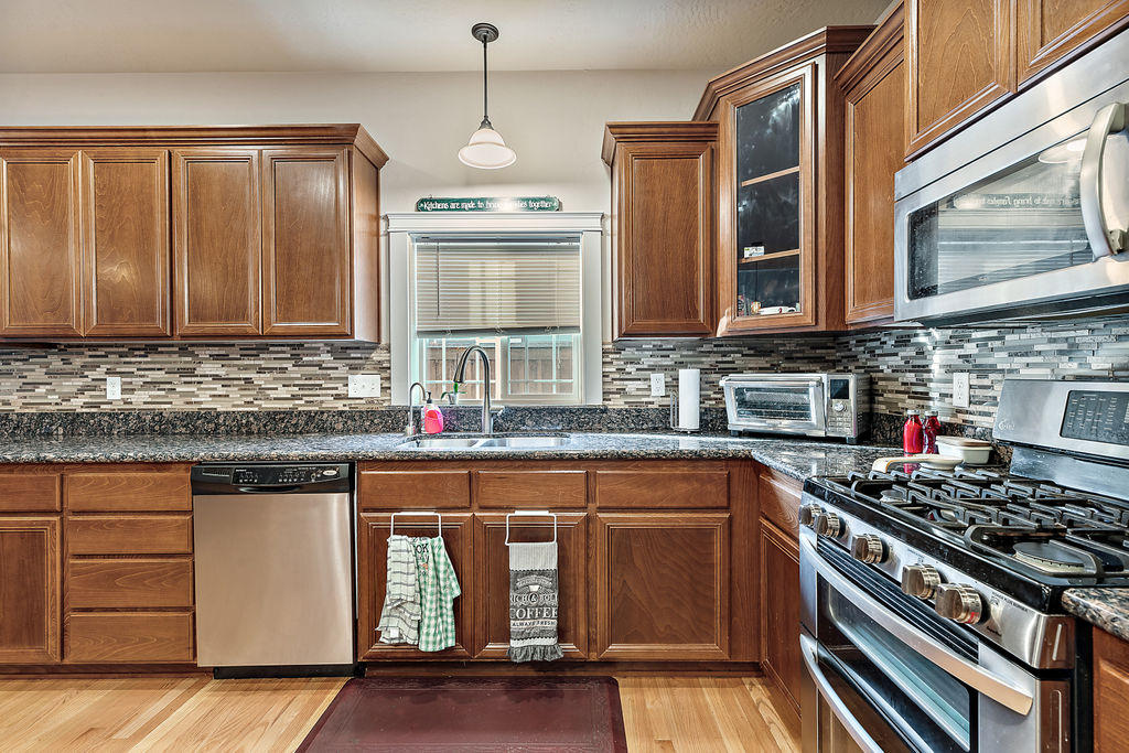 2198 Rabun Way Central Point, OR 97502 - Photo 24 of 47 a kitchen with stainless steel appliances granite countertop a stove and a sink