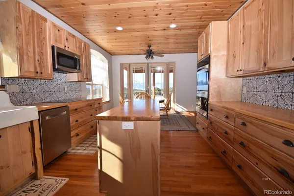 a kitchen with sink stove and cabinets