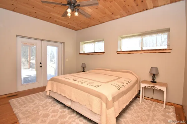 a bedroom with a bed and a chandelier