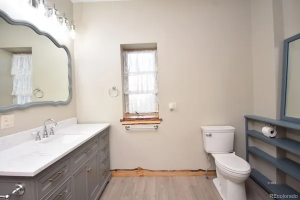 a bathroom with a toilet sink and mirror