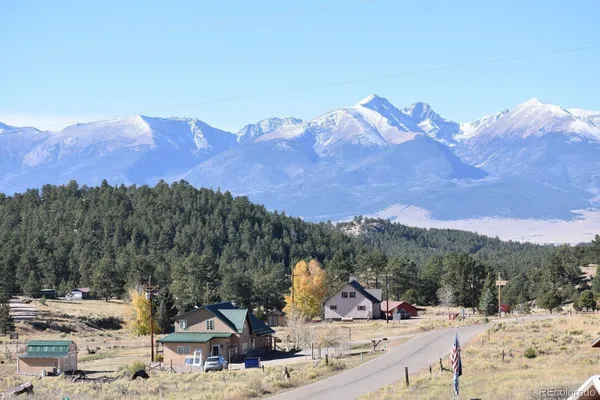 a view of a town with mountains in the background