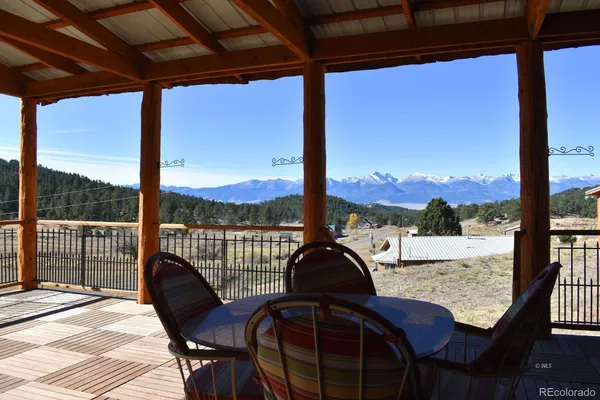 a view of a balcony with a table and chairs