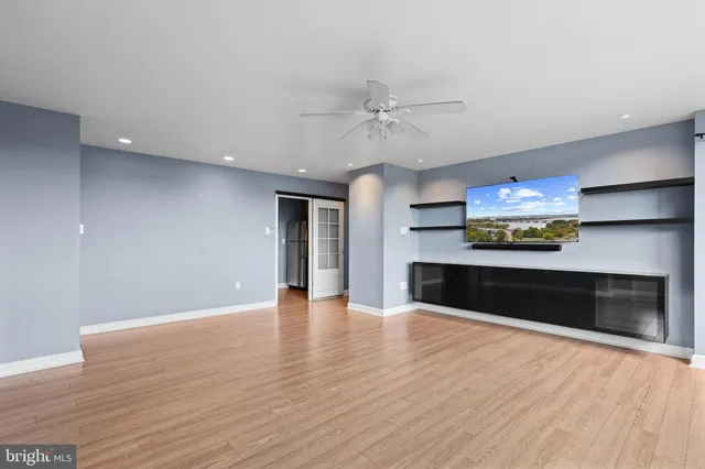 a view of an empty room with a fireplace and a window